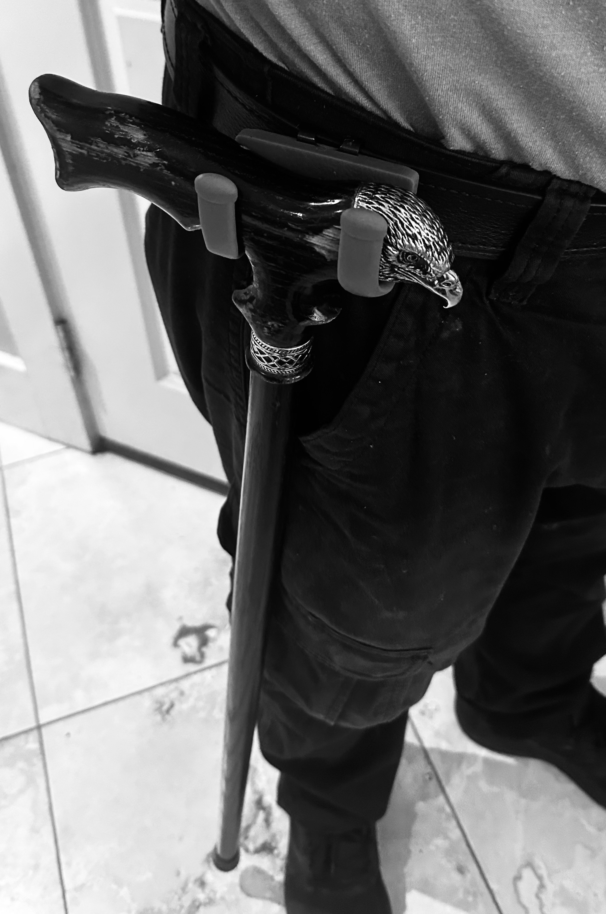 Bishop Mobility Cane Holster in use - showing the dual S-curved design holding a cane securely on a belt